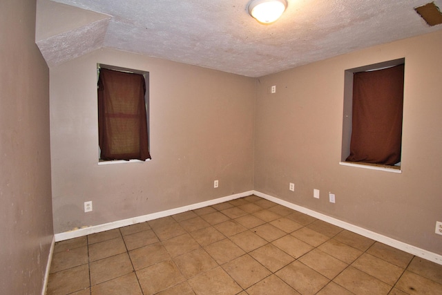 23627 Glenwood Rd, Cassopolis, MI 49031 - tiled spare room featuring a textured ceiling and baseboards