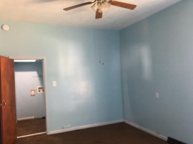 unfurnished room featuring a ceiling fan and a smoke detector