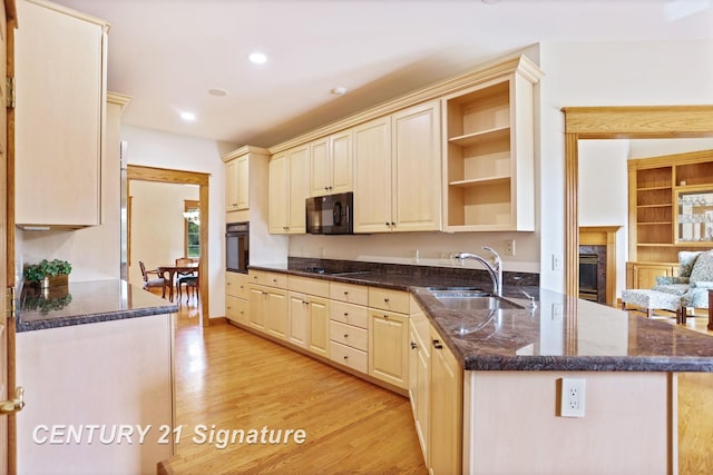 43 Sawmill Creek Trl, Saginaw, MI 48603 - kitchen with black appliances, open shelves, light wood-style floors, a peninsula, and dark stone counters