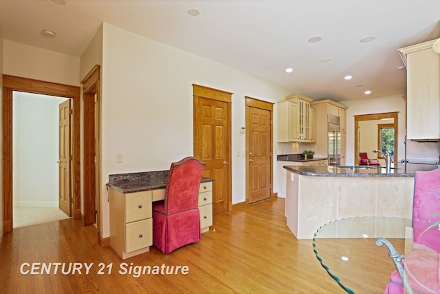 43 Sawmill Creek Trl, Saginaw, MI 48603 - kitchen with cream cabinetry, light wood-style floors, a peninsula, recessed lighting, and dark stone countertops