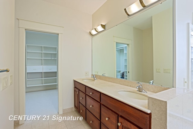 43 Sawmill Creek Trl, Saginaw, MI 48603 - full bath with double vanity, a walk in closet, and tile patterned floors