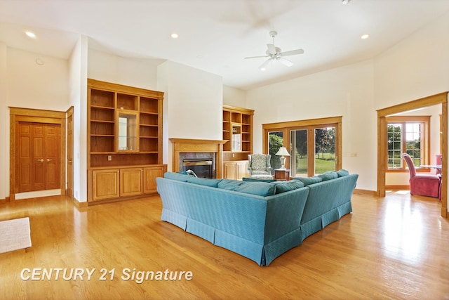 43 Sawmill Creek Trl, Saginaw, MI 48603 - living room with a premium fireplace, light wood finished floors, a ceiling fan, recessed lighting, and a high ceiling