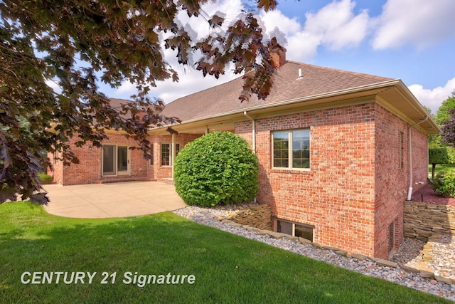 43 Sawmill Creek Trl, Saginaw, MI 48603 - rear view of house featuring brick siding, a lawn, a shingled roof, and a patio