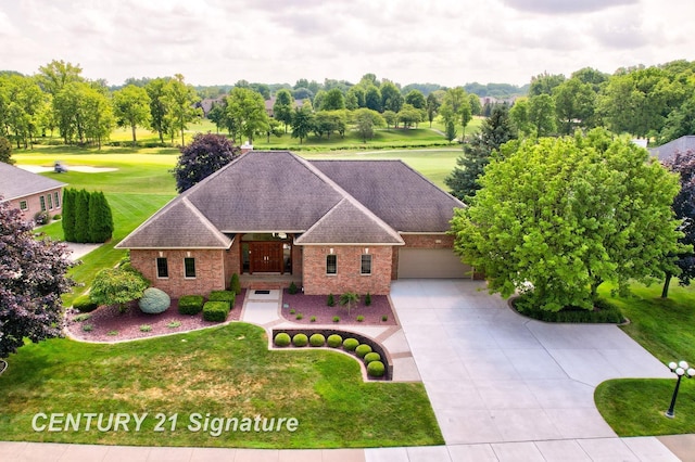 43 Sawmill Creek Trl, Saginaw, MI 48603 - view of front facade featuring concrete driveway, brick siding, a shingled roof, and a front yard