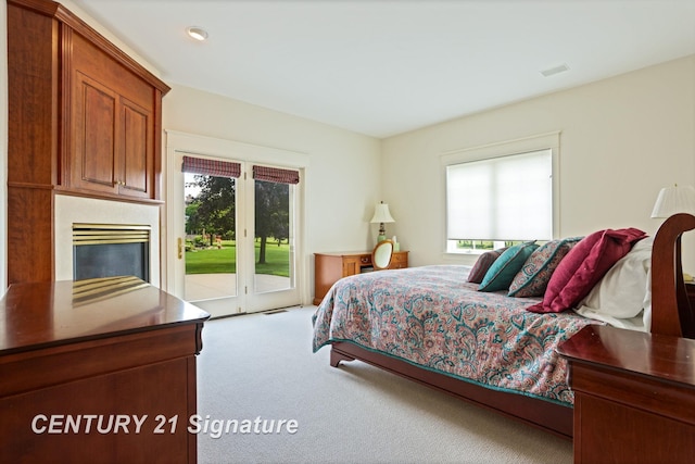 43 Sawmill Creek Trl, Saginaw, MI 48603 - carpeted bedroom with access to outside and a high end fireplace