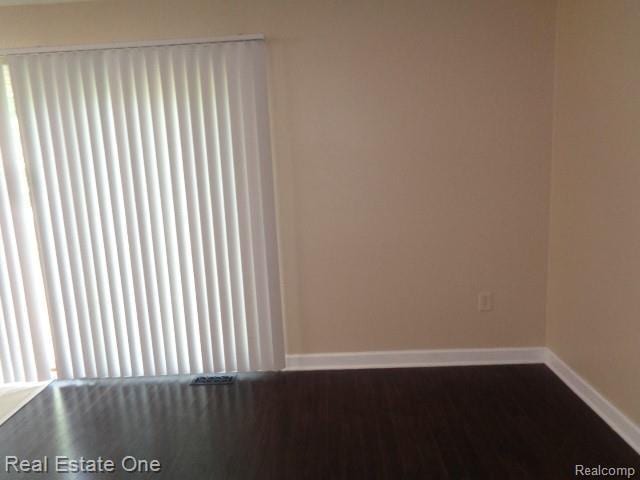 26537 Summerdale Dr, Southfield, MI 48033 - spare room with baseboards and dark wood finished floors