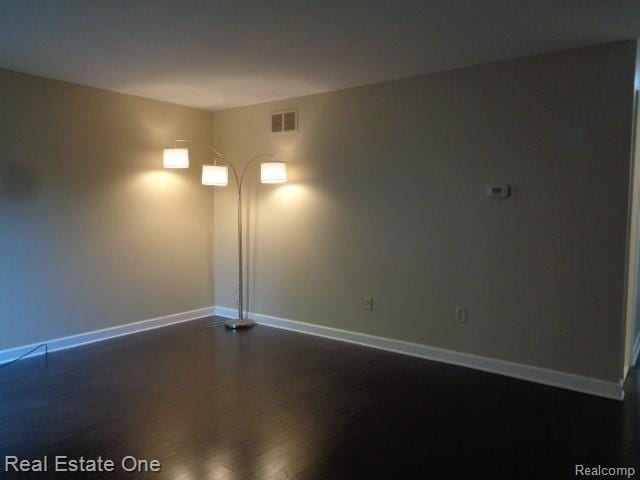 26537 Summerdale Dr, Southfield, MI 48033 - spare room with baseboards and dark wood-style floors