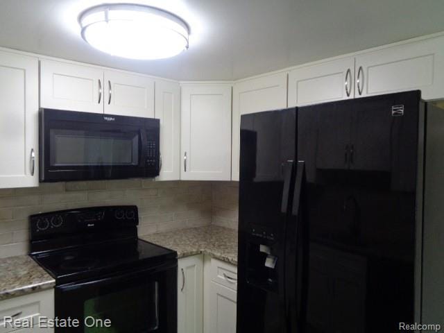 26537 Summerdale Dr, Southfield, MI 48033 - kitchen featuring black appliances, white cabinets, backsplash, and light stone counters