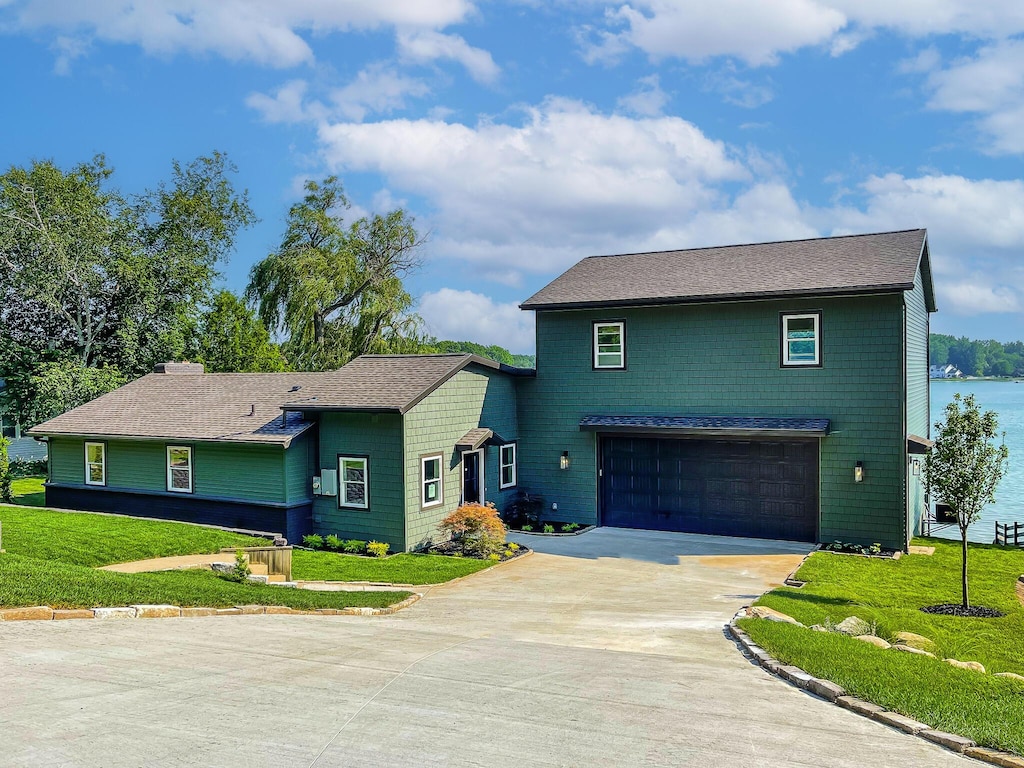 12475 Oakwood Shores St, Wayland, MI 49348 - view of front facade featuring driveway, a garage, a front yard, and a shingled roof