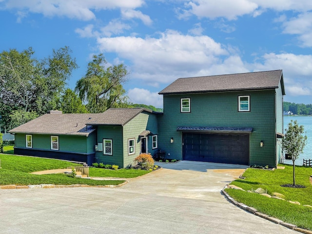 12475 Oakwood Shores St, Wayland, MI 49348 - view of front facade featuring driveway, a garage, a front yard, and a shingled roof