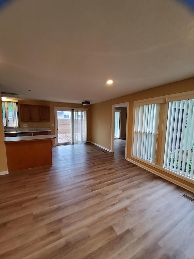 2828 Packard St, Ann Arbor, MI 48108 - unfurnished living room with light wood-type flooring and recessed lighting