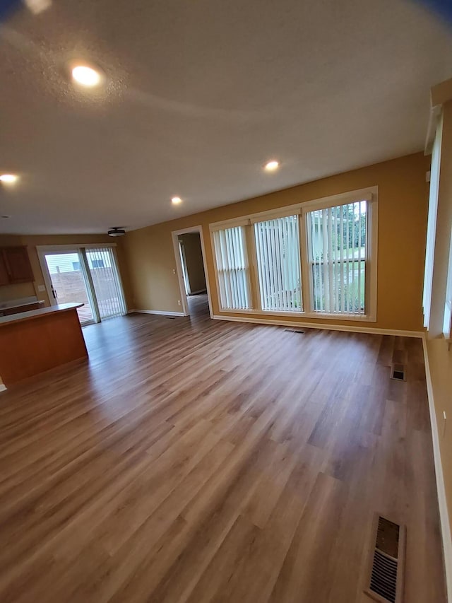 2828 Packard St, Ann Arbor, MI 48108 - unfurnished living room featuring wood finished floors and recessed lighting