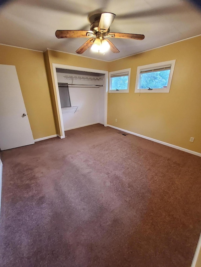 2828 Packard St, Ann Arbor, MI 48108 - unfurnished bedroom with carpet flooring, a ceiling fan, and a closet