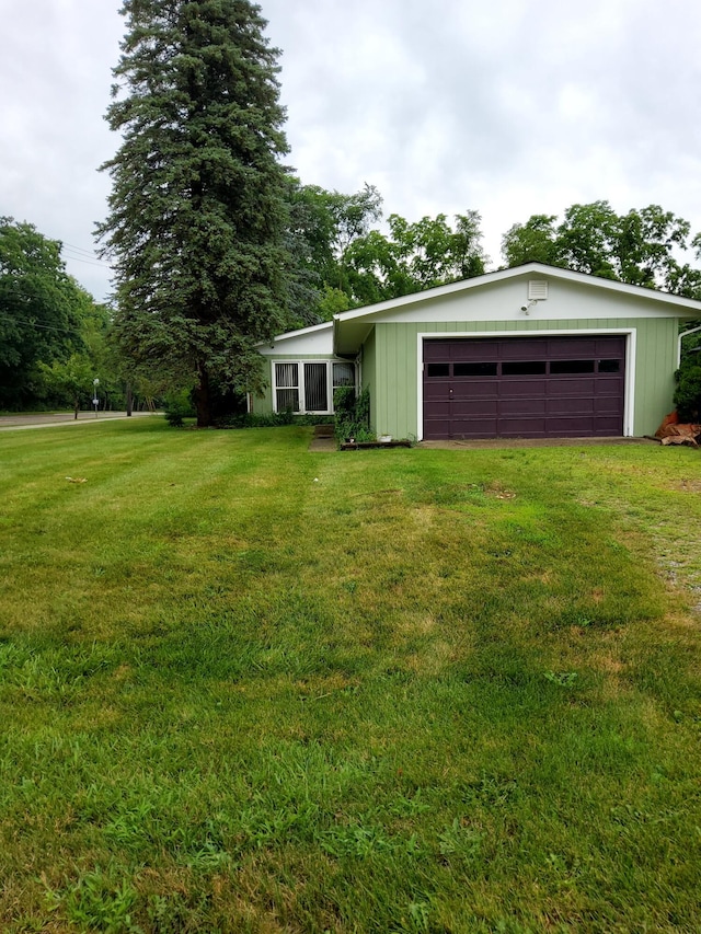 2828 Packard St, Ann Arbor, MI 48108 - view of front of home featuring a front yard, driveway, and a garage