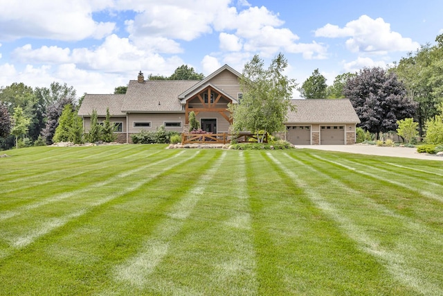 12500 Round Lake Rd, Horton, MI 49246 - view of front of home featuring a front lawn, a garage, a chimney, and driveway