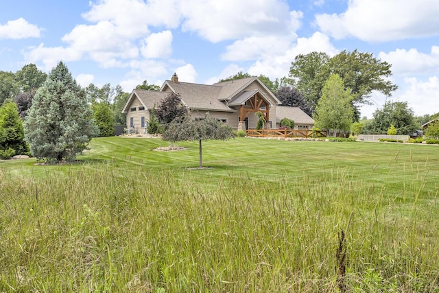 12500 Round Lake Rd, Horton, MI 49246 - view of front of house with a chimney and a front lawn