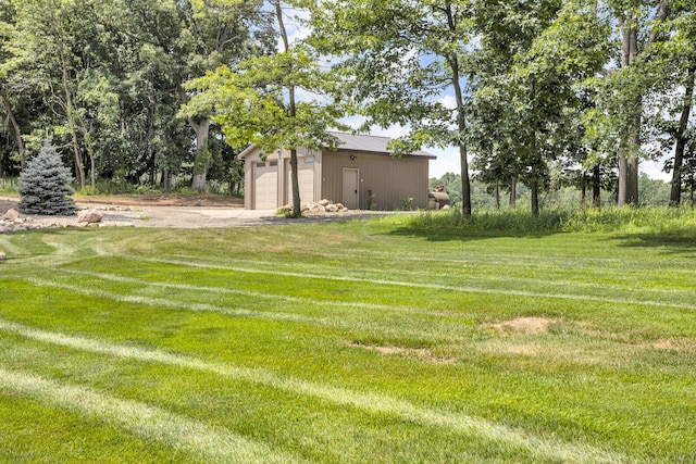 12500 Round Lake Rd, Horton, MI 49246 - view of grassy yard featuring an outbuilding, driveway, and a detached garage