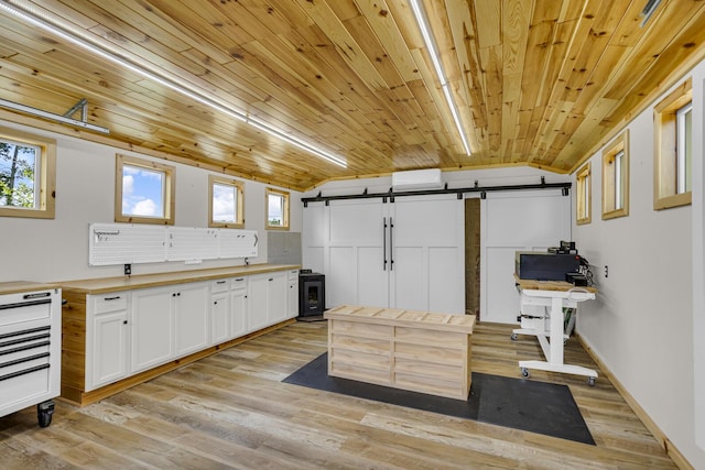 12500 Round Lake Rd, Horton, MI 49246 - kitchen featuring butcher block counters, a barn door, plenty of natural light, white cabinets, and wood ceiling