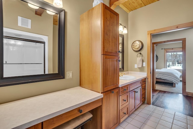 12500 Round Lake Rd, Horton, MI 49246 - ensuite bathroom with vanity, tile patterned floors, and wooden ceiling