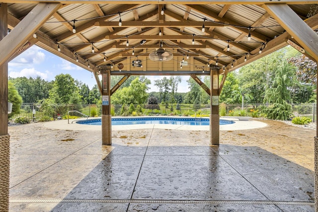 12500 Round Lake Rd, Horton, MI 49246 - view of pool featuring a patio, view of wooded area, and a gazebo