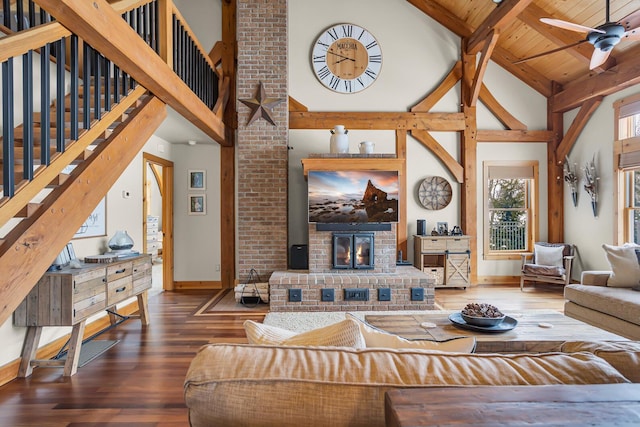 12500 Round Lake Rd, Horton, MI 49246 - living room with high vaulted ceiling, wood-type flooring, a fireplace, stairway, and ceiling fan