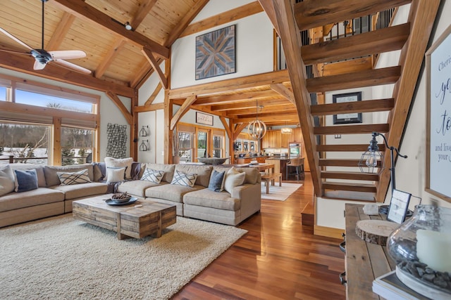 12500 Round Lake Rd, Horton, MI 49246 - living room with wood finished floors, high vaulted ceiling, stairway, a wood ceiling with exposed beams, and a chandelier
