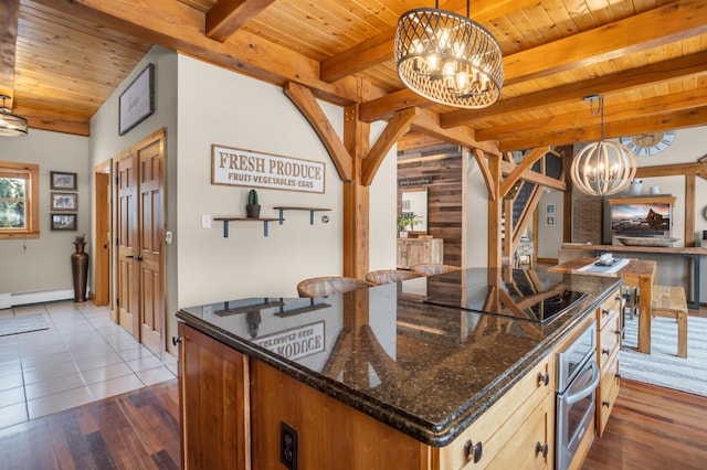 12500 Round Lake Rd, Horton, MI 49246 - kitchen with a chandelier, stainless steel oven, black electric stovetop, a wooden ceiling with exposed beams, and dark stone counters