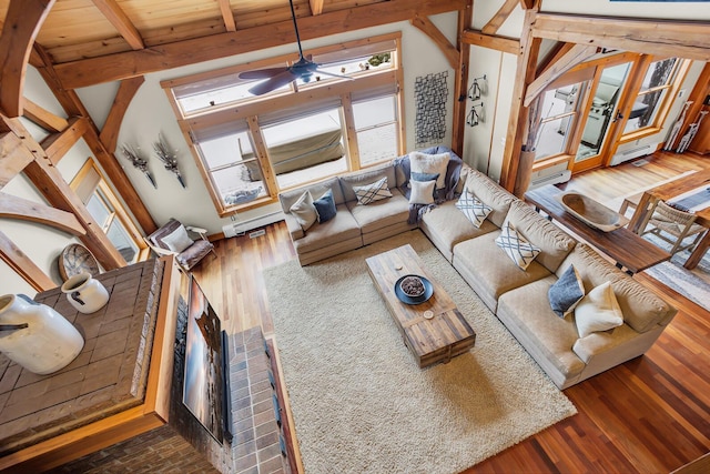 12500 Round Lake Rd, Horton, MI 49246 - living area with plenty of natural light, a ceiling fan, beam ceiling, and wood finished floors