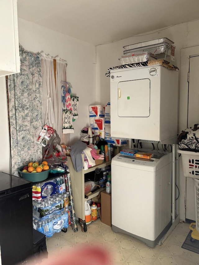 1069 E Main St, Benton Harbor, MI 49022 - laundry area featuring stacked washer and clothes dryer and light floors