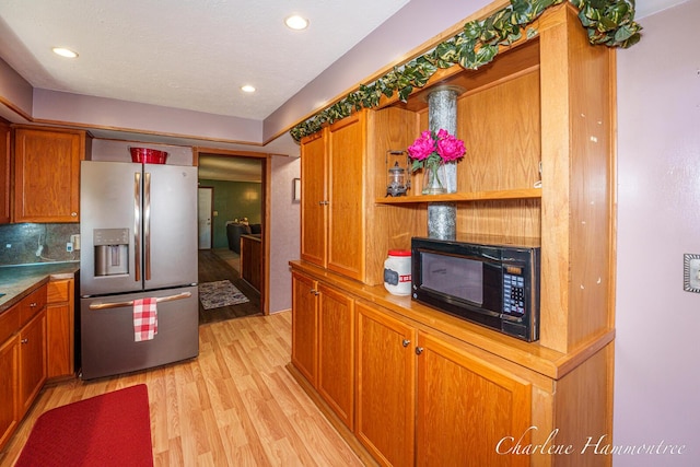 126 E Cherry St, Wayland, MI 49348 - kitchen with stainless steel fridge with ice dispenser, black microwave, light wood-type flooring, brown cabinets, and recessed lighting