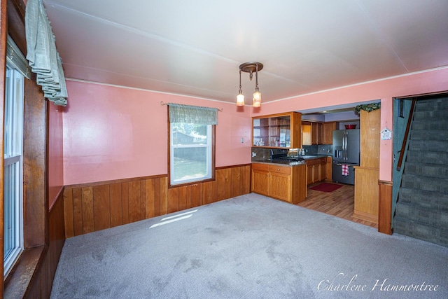 126 E Cherry St, Wayland, MI 49348 - kitchen featuring refrigerator with ice dispenser, brown cabinets, carpet flooring, a wainscoted wall, and wooden walls