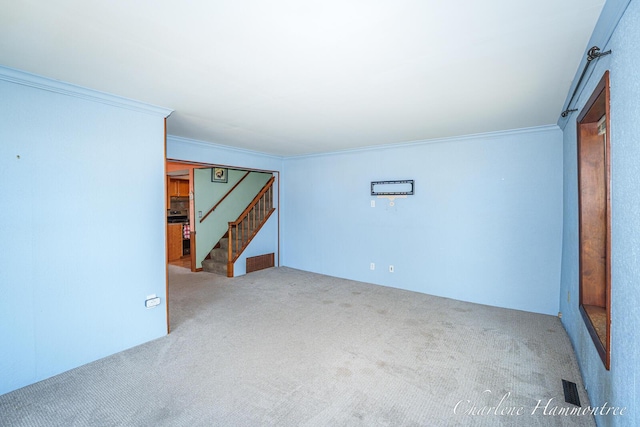 126 E Cherry St, Wayland, MI 49348 - carpeted empty room with crown molding and stairway