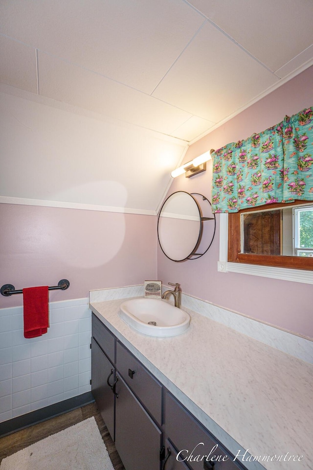 126 E Cherry St, Wayland, MI 49348 - bathroom featuring vanity, tile walls, and lofted ceiling