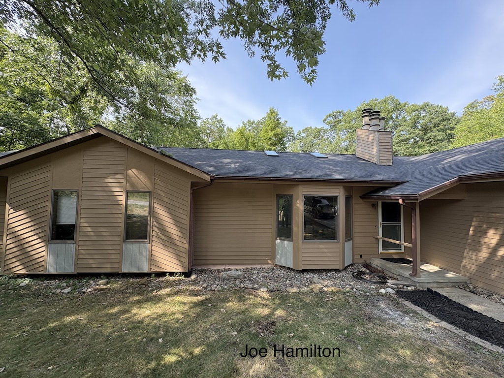5497 Coit Ave NE, Grand Rapids, MI 49525 - rear view of property with a chimney