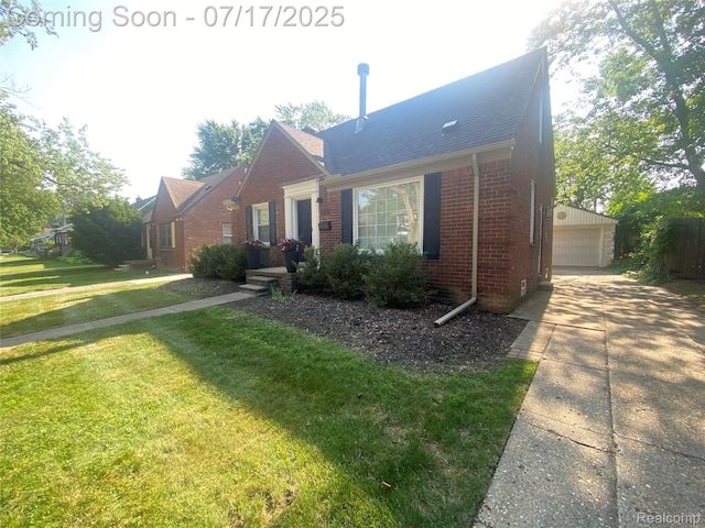 1417 N Maple Ave, Royal Oak, MI 48067 - view of front facade with brick siding, a front yard, a garage, an outdoor structure, and roof with shingles