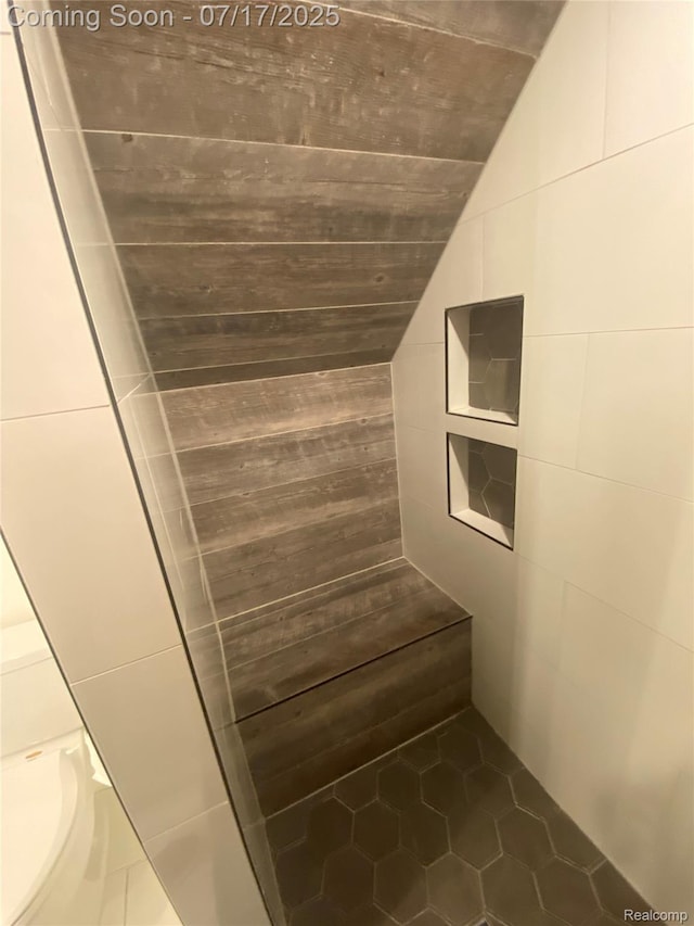 1417 N Maple Ave, Royal Oak, MI 48067 - bathroom featuring vaulted ceiling, tile patterned floors, tiled shower, and tile walls