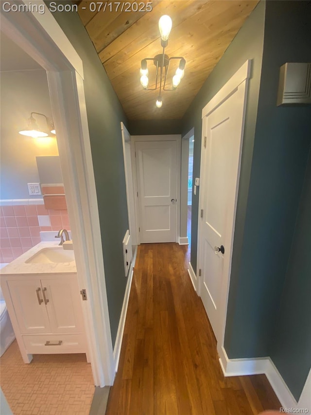 1417 N Maple Ave, Royal Oak, MI 48067 - corridor featuring wood finished floors, wooden ceiling, and a chandelier