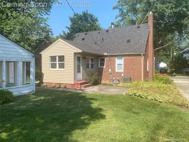 1417 N Maple Ave, Royal Oak, MI 48067 - rear view of house featuring a chimney, a yard, roof with shingles, and brick siding