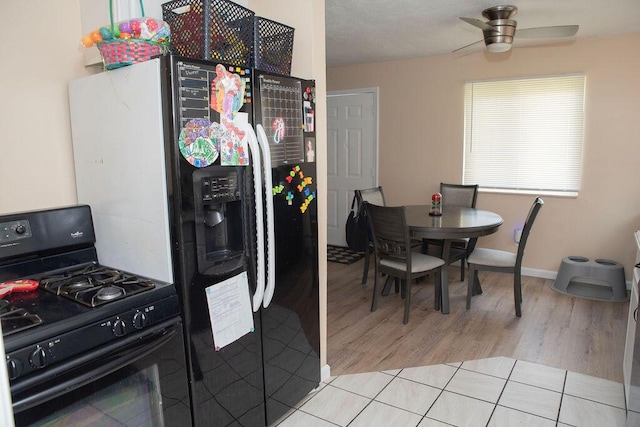 9641 Wilkie St, Taylor, MI 48180 - kitchen with black gas stove, light wood finished floors, and a ceiling fan