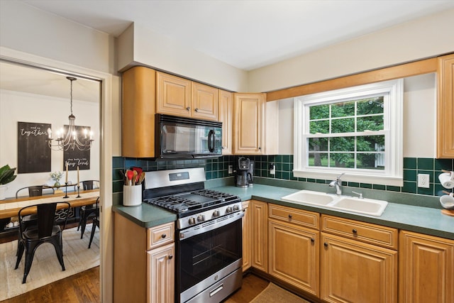 539 Old Bridge Rd, Grand Blanc, MI 48439 - kitchen with stainless steel range with gas stovetop, black microwave, a chandelier, dark wood-type flooring, and decorative backsplash