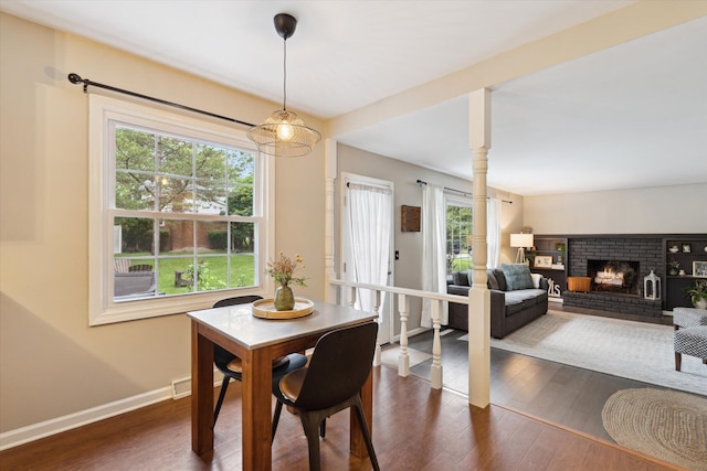 539 Old Bridge Rd, Grand Blanc, MI 48439 - dining room with dark wood-style floors and a brick fireplace