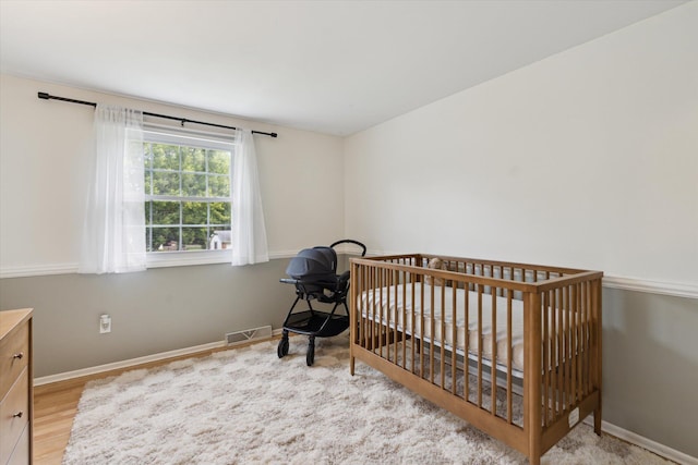 539 Old Bridge Rd, Grand Blanc, MI 48439 - bedroom with wood finished floors and a nursery area