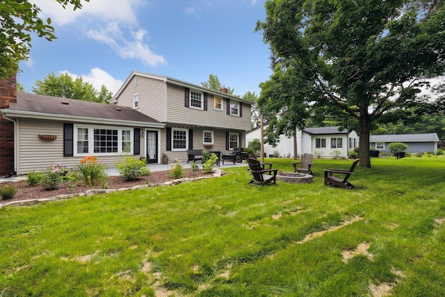 539 Old Bridge Rd, Grand Blanc, MI 48439 - back of house with an outdoor fire pit, a chimney, a yard, a patio area, and entry steps
