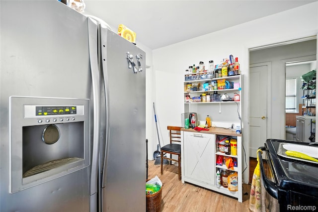 18995 Fielding St, Detroit, MI 48219 - kitchen featuring stainless steel fridge, wood finished floors, and black range with electric cooktop