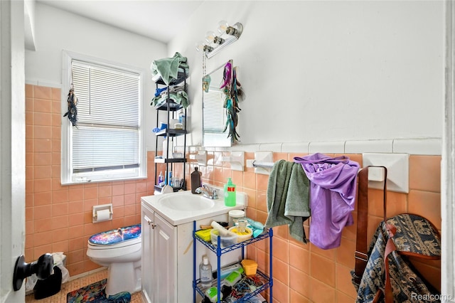 18995 Fielding St, Detroit, MI 48219 - bathroom featuring tile walls, vanity, and wainscoting