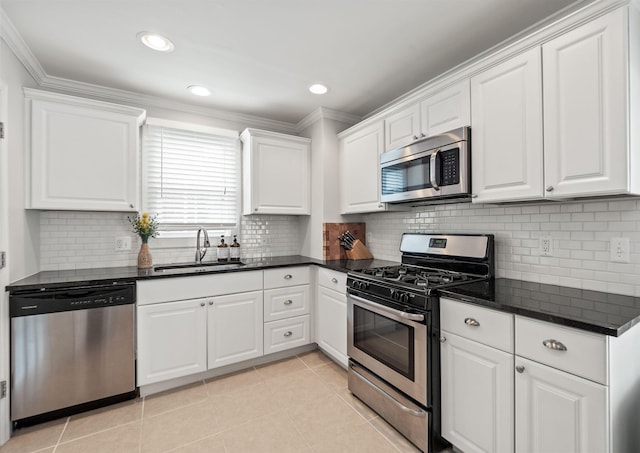 2213 N Wilson Ave, Royal Oak, MI 48073 - kitchen featuring stainless steel appliances, white cabinetry, light tile patterned floors, ornamental molding, and tasteful backsplash