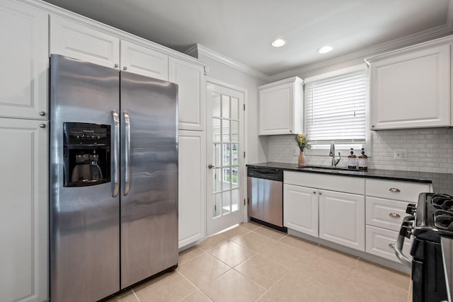 2213 N Wilson Ave, Royal Oak, MI 48073 - kitchen featuring appliances with stainless steel finishes, dark countertops, white cabinets, decorative backsplash, and crown molding