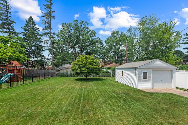 2213 N Wilson Ave, Royal Oak, MI 48073 - view of yard with a detached garage, a playground, an outbuilding, and driveway