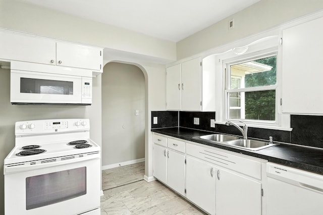 2707 Byron Center Ave SW, Wyoming, MI 49519 - kitchen featuring white appliances, light marble finish flooring, backsplash, and arched walkways