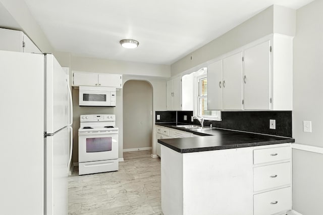 2707 Byron Center Ave SW, Wyoming, MI 49519 - kitchen featuring white appliances, light marble finish flooring, arched walkways, a peninsula, and backsplash